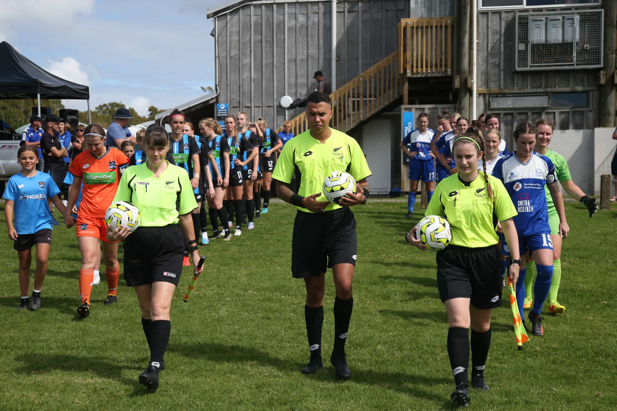 The match officials lead the teams onto the pitch. 
LOTTO NRFL Women Premiership 2023, West Coast Rangers v Hamilton Wanderers, Fred Taylor Park Auckland, Saturday 25th March 2023. Photo: Jackie Tran Van / www.phototek.nz