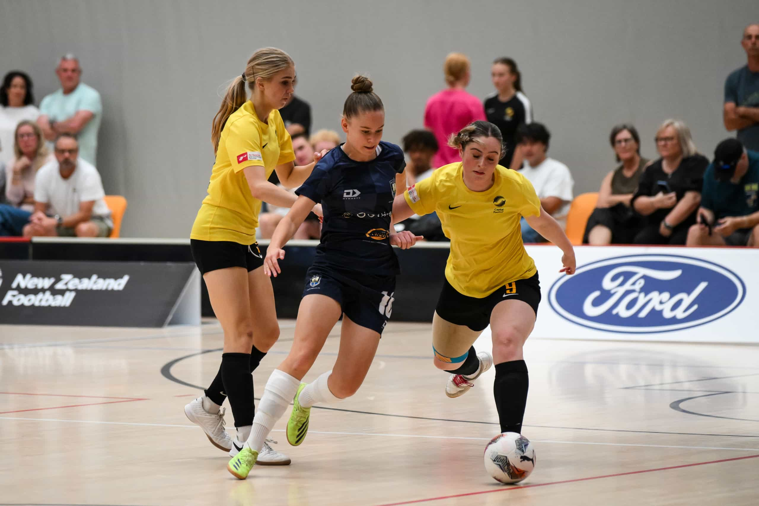 Zoe Benson of Auckland City beats defender. Under 19 girls final Capital Futsal Vs Auckland City. Youth Futsal Championship at Akau Tangi Sports Centre, Wellington, New Zealand on December 10, 2024. Mandatory credit: Elias Rodriguez / www.photosport.nz