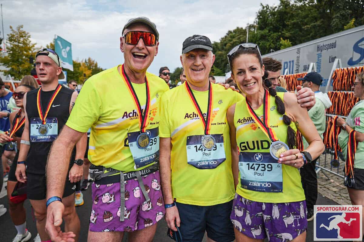 Paul, Rosie and Tony with medals at the finish line in Berlin