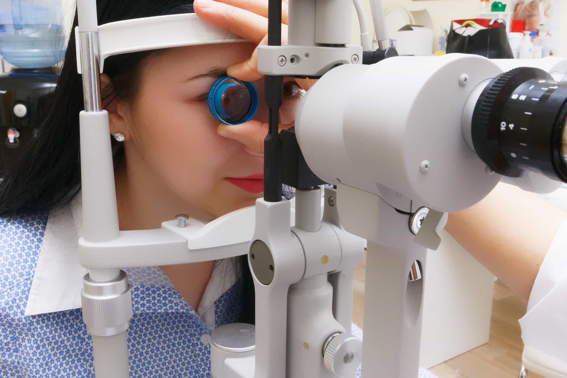 a woman sitting to get her vision tested. 