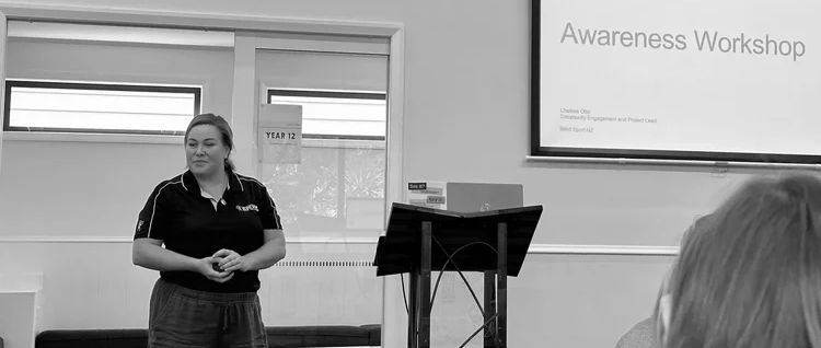 A women standing in front of a group of people doing Awareness Training 