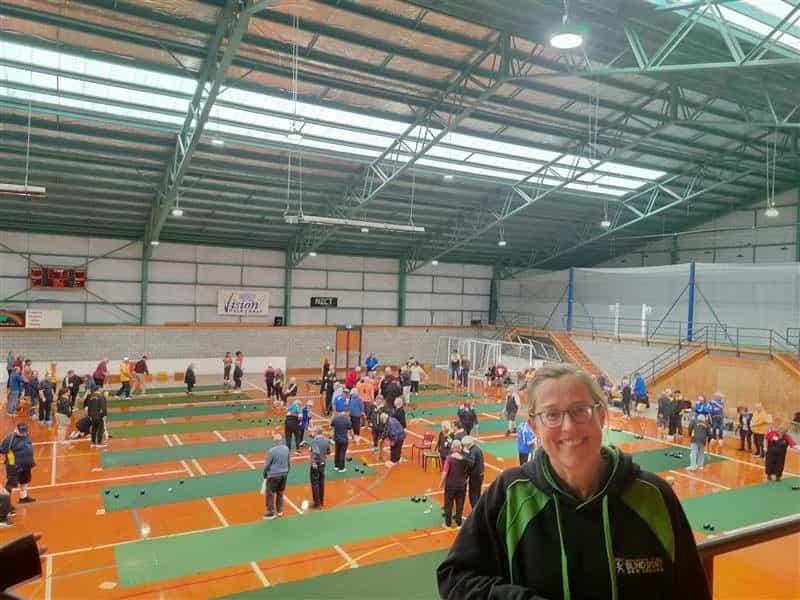 Women smiling and standing in front of New Zealand Blind and Vision Impaired Indoor Bowls Competition