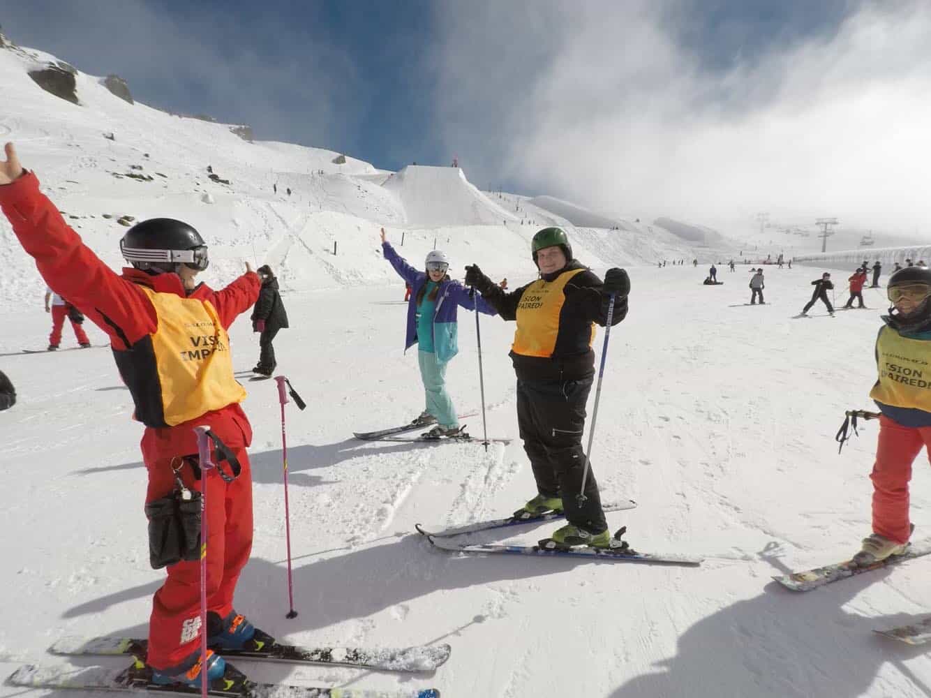 People standing in skiing gear in front of a snowy mountain - Hannah Jones 